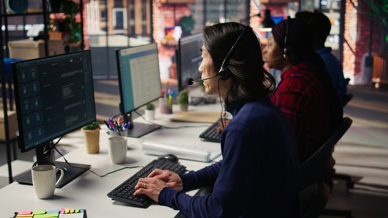 experienced call center employee listening to customer inquiries